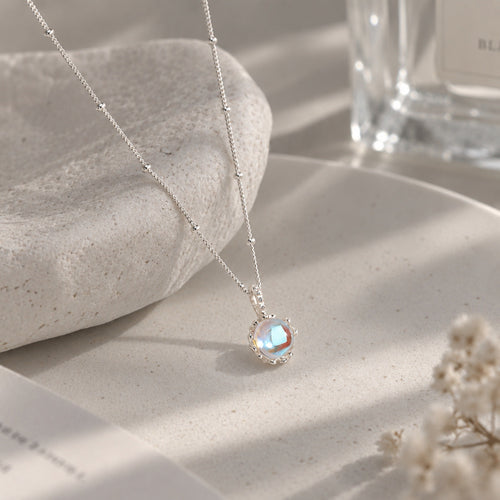 Sparkling Aurora Moonstone Pendant Satellite Necklace on stone display