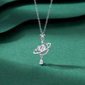 Sparkling Celestial Heart Planet Pendant Necklace on green background